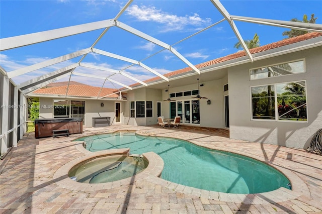 view of swimming pool with a patio area, ceiling fan, a hot tub, and a lanai