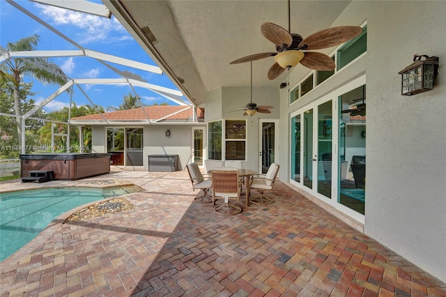 view of patio / terrace with glass enclosure, a swimming pool with hot tub, and ceiling fan