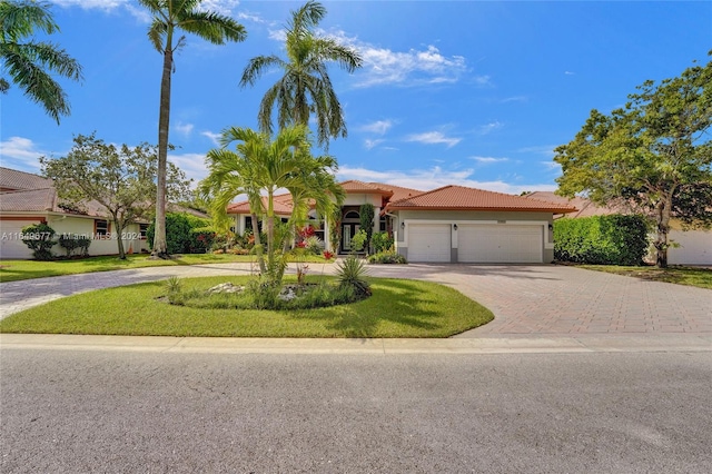 view of front of house with a front yard and a garage