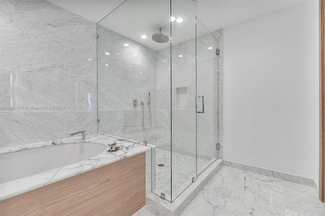 bathroom featuring shower with separate bathtub