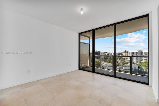 empty room featuring expansive windows and plenty of natural light