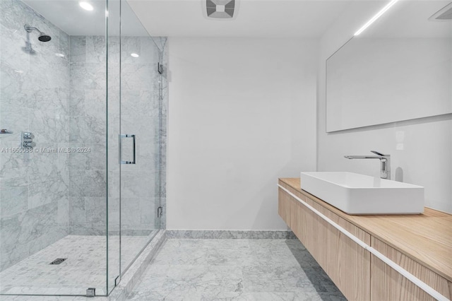 bathroom featuring vanity and a shower with shower door