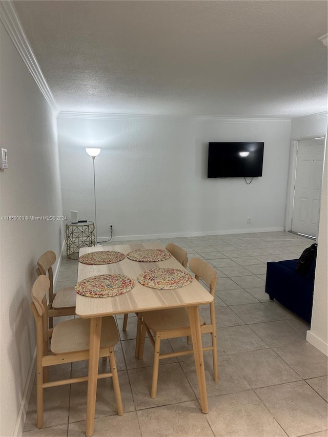 dining area featuring crown molding, a textured ceiling, and light tile patterned flooring