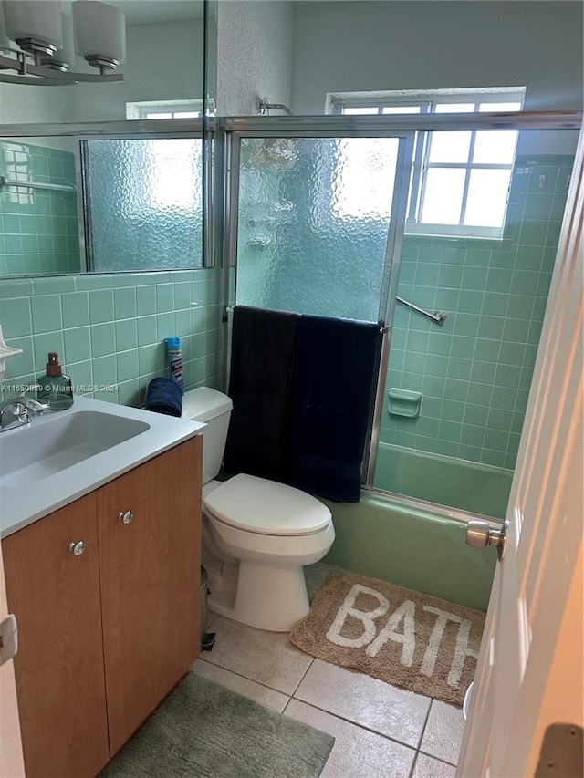 full bathroom featuring tile patterned flooring, toilet, tile walls, decorative backsplash, and vanity