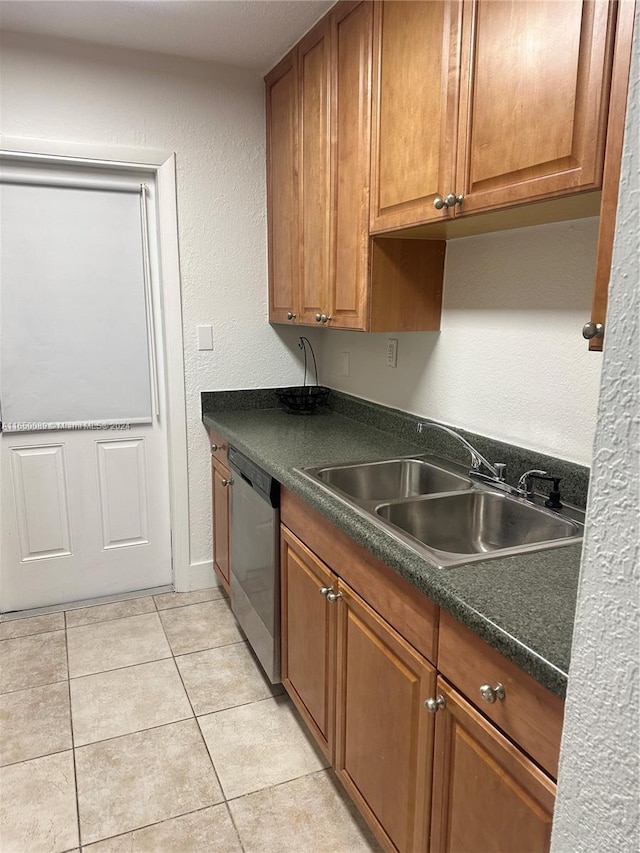 kitchen with stainless steel dishwasher, sink, and light tile patterned floors