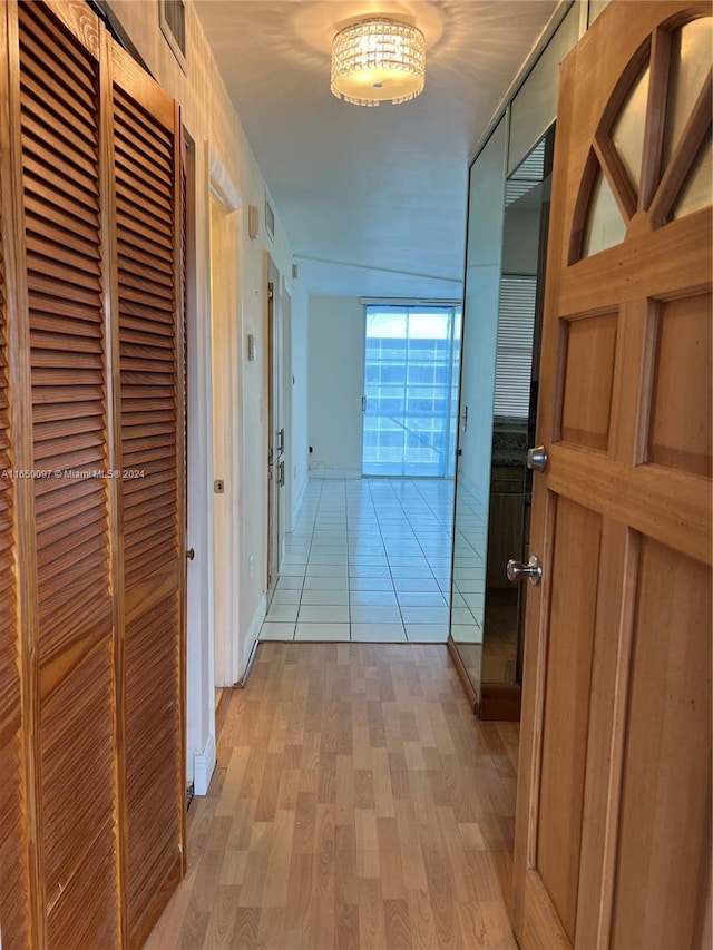 hallway with light hardwood / wood-style floors