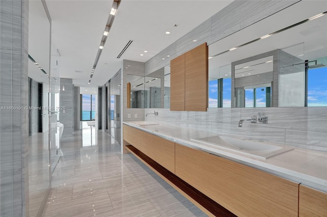 bathroom featuring floor to ceiling windows and separate shower and tub