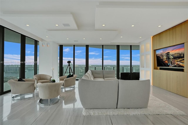 living room with a water view and expansive windows