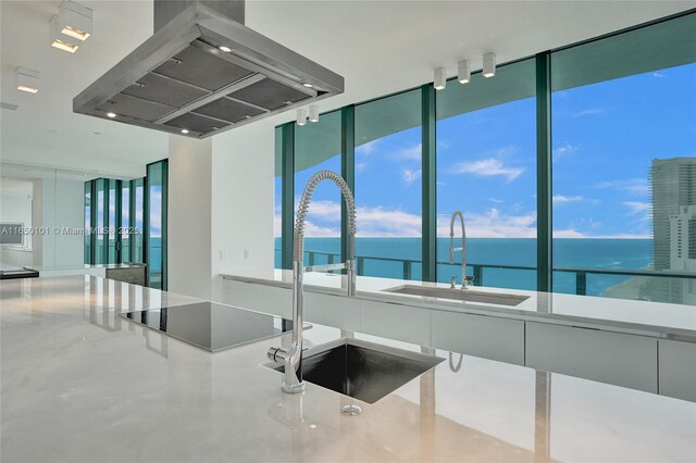 19575 Collins Ave Unit 33, Sunny Isles Beach, FL 33160 - kitchen with wall chimney exhaust hood, a sink, a water view, black electric stovetop, and a wall of windows