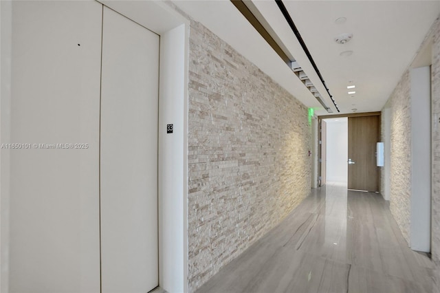 19575 Collins Ave Unit 33, Sunny Isles Beach, FL 33160 - corridor with elevator and brick wall