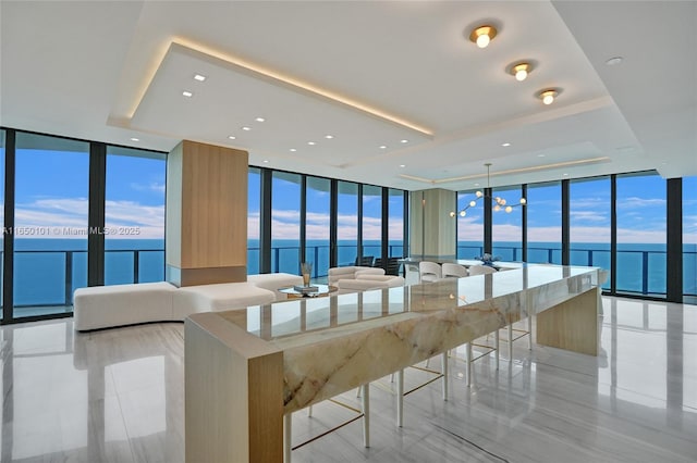 kitchen with a water view, floor to ceiling windows, and a kitchen island