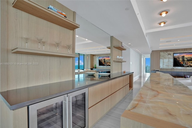 kitchen featuring light brown cabinetry, beverage cooler, and light tile patterned flooring