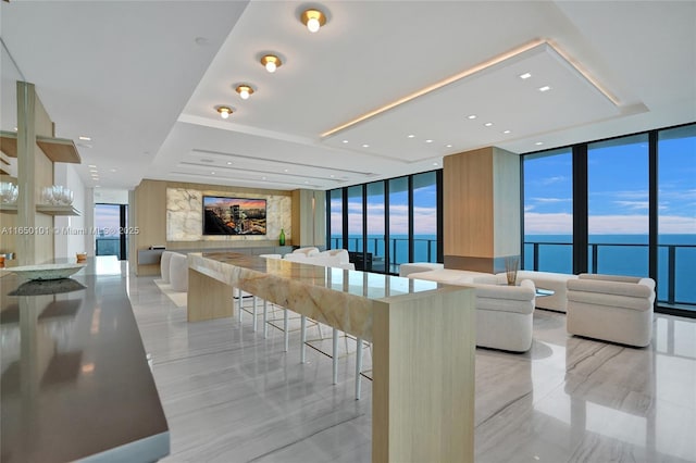 kitchen with a breakfast bar area, a kitchen island, and expansive windows