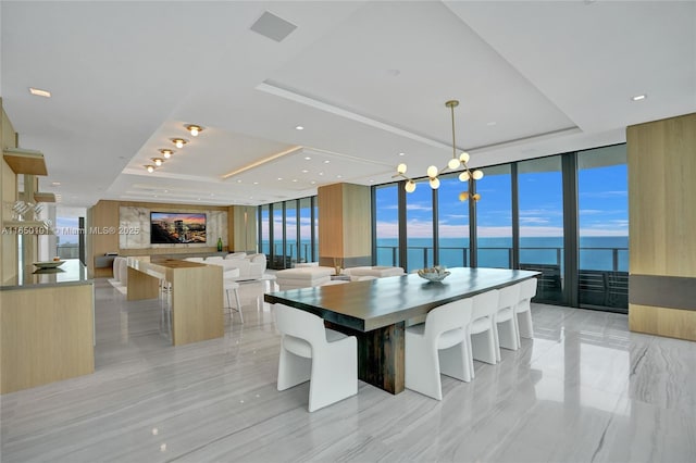 19575 Collins Ave Unit 33, Sunny Isles Beach, FL 33160 - dining space featuring a raised ceiling, expansive windows, and a chandelier