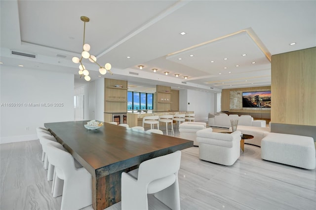 dining space featuring a raised ceiling