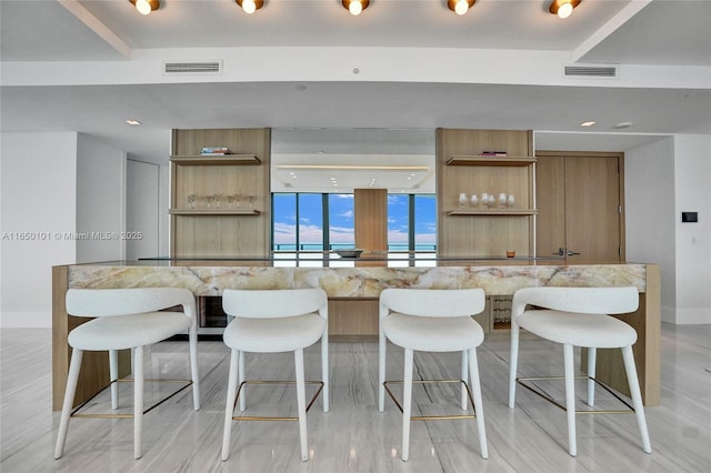 kitchen featuring floor to ceiling windows and a breakfast bar