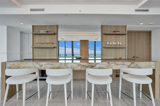 kitchen with a breakfast bar area and expansive windows