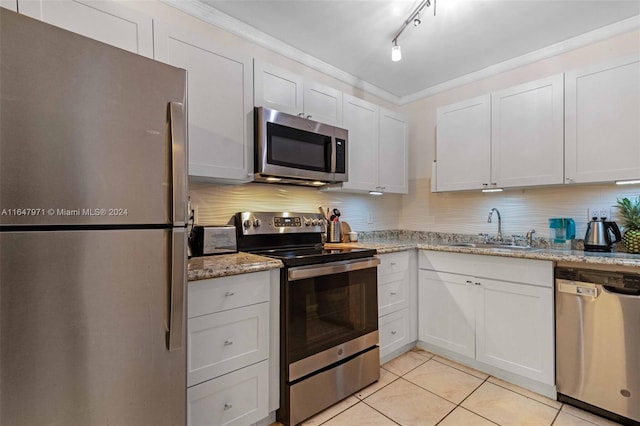 kitchen with stainless steel appliances, sink, white cabinetry, and track lighting