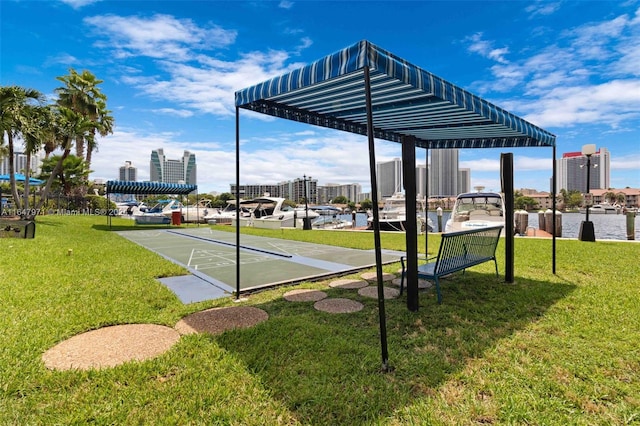 view of home's community featuring a yard and a water view