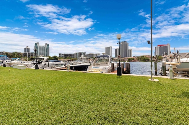 view of dock featuring a water view and a yard