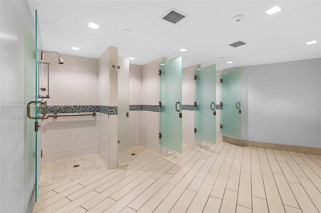 bathroom featuring an enclosed shower and tile patterned floors