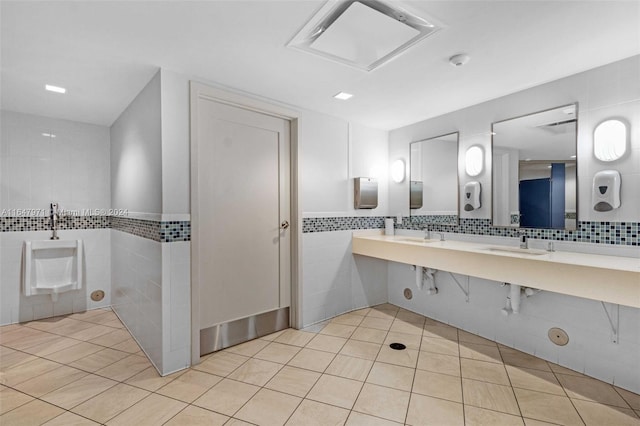 bathroom with tile patterned flooring, tile walls, and tasteful backsplash