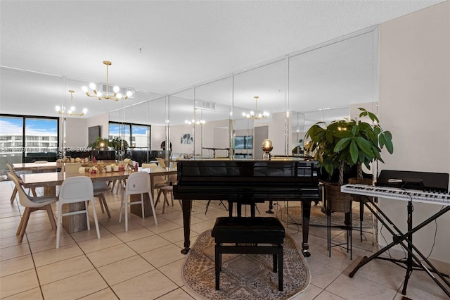 misc room with a textured ceiling, light tile patterned flooring, and a notable chandelier