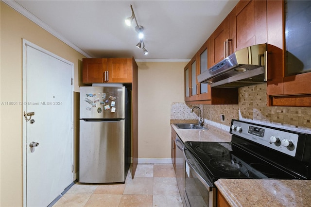 kitchen featuring track lighting, sink, decorative backsplash, appliances with stainless steel finishes, and extractor fan