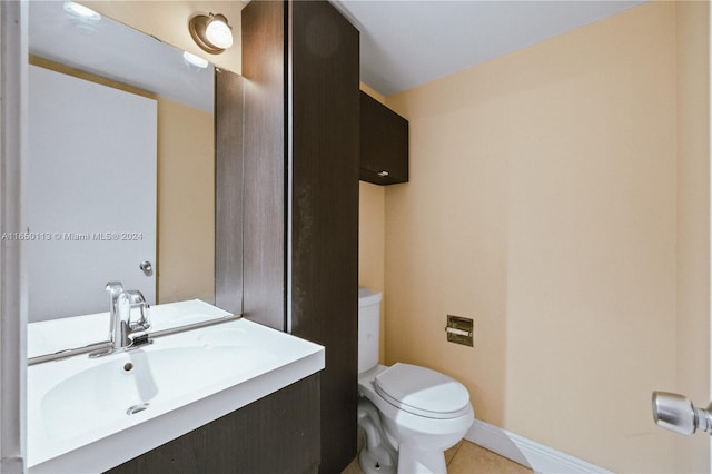 bathroom with vanity, toilet, and tile patterned floors