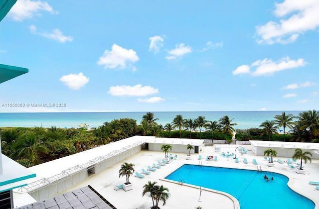 view of pool with a patio and a water view