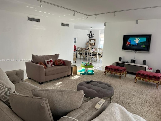 living room with rail lighting and carpet