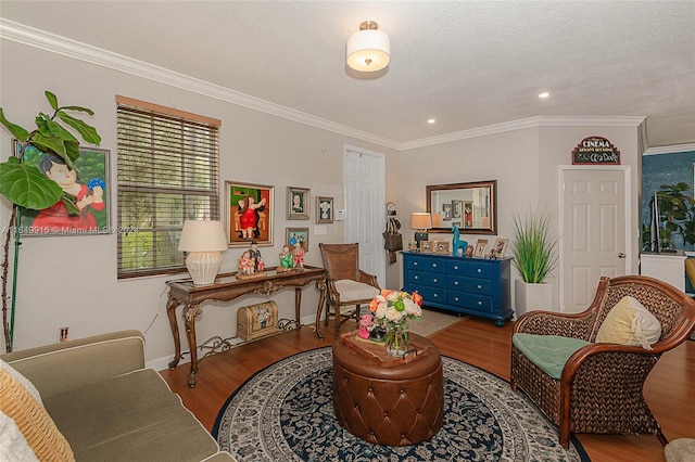 living room featuring ornamental molding, a textured ceiling, and hardwood / wood-style flooring