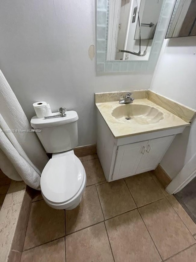 bathroom featuring vanity, toilet, and tile patterned floors