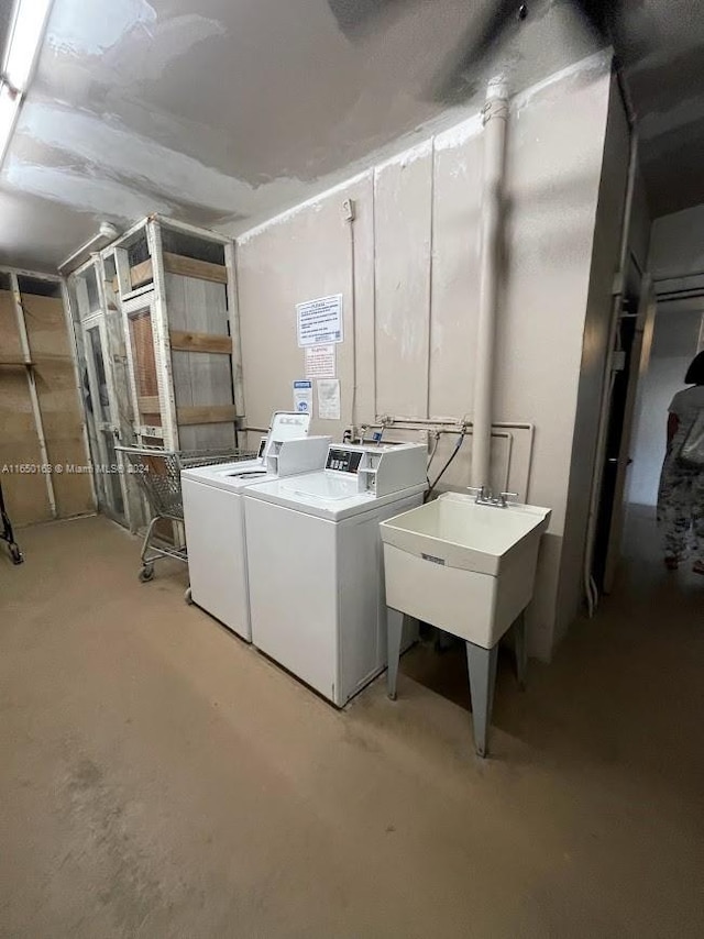 laundry room with separate washer and dryer and sink