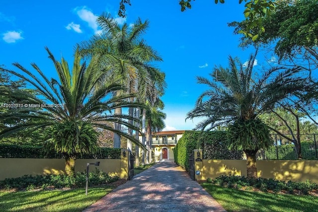 view of home's community featuring a fenced front yard and decorative driveway