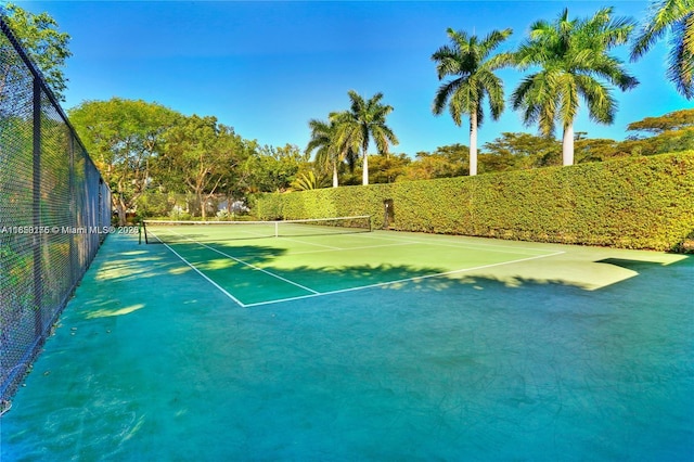 view of tennis court with fence