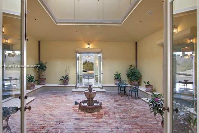 entrance to property featuring a patio, visible vents, and stucco siding