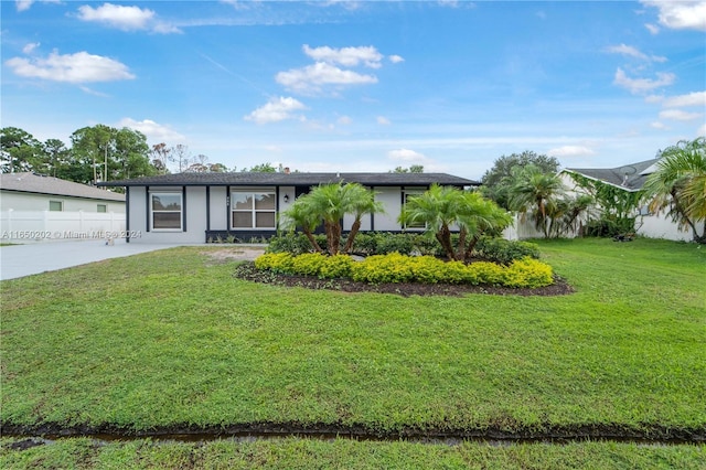 ranch-style house with a front lawn