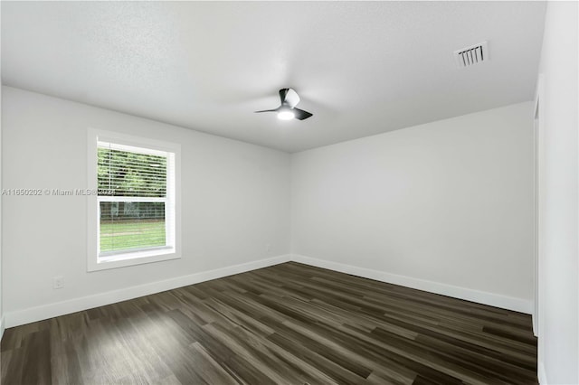 unfurnished room with dark hardwood / wood-style flooring and ceiling fan