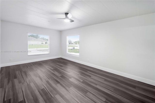 empty room featuring ceiling fan and dark hardwood / wood-style flooring