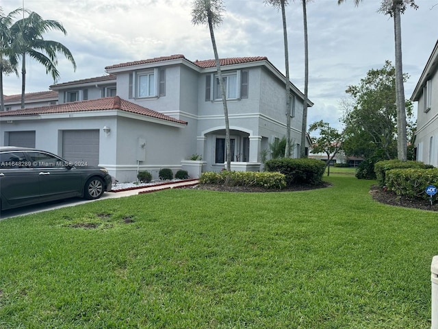 mediterranean / spanish-style home featuring a garage, stucco siding, a tile roof, and a front yard