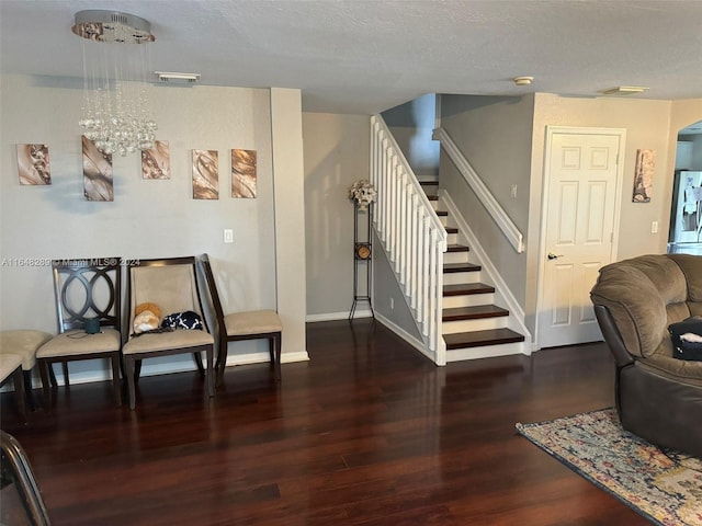 interior space featuring visible vents, baseboards, stairs, wood finished floors, and arched walkways