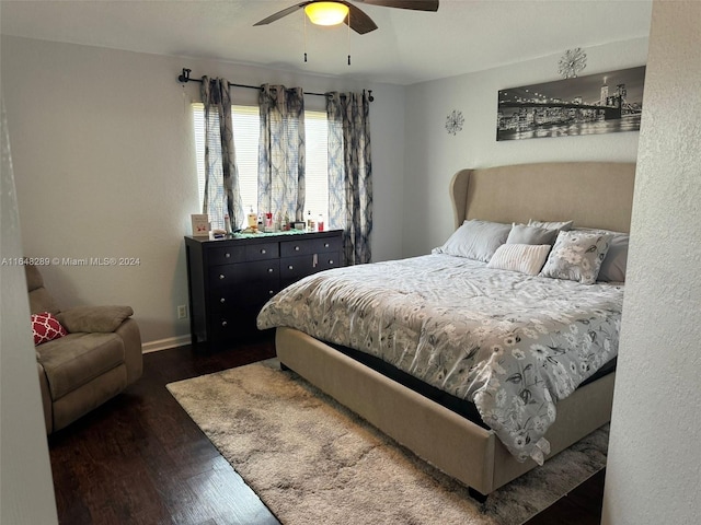 bedroom with ceiling fan, baseboards, and wood finished floors