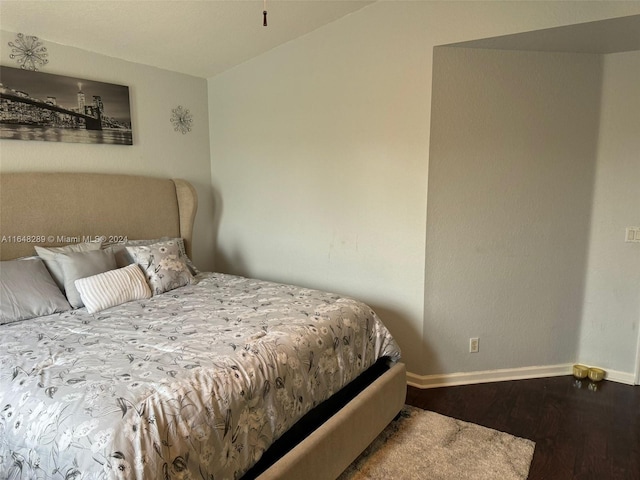 bedroom with baseboards and wood finished floors