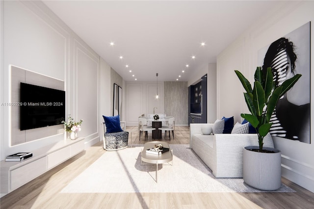 living area featuring light wood finished floors and a decorative wall
