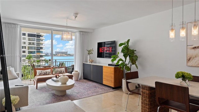 living room featuring a wall of windows and a chandelier