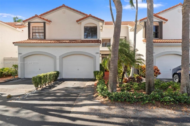 mediterranean / spanish house with a garage