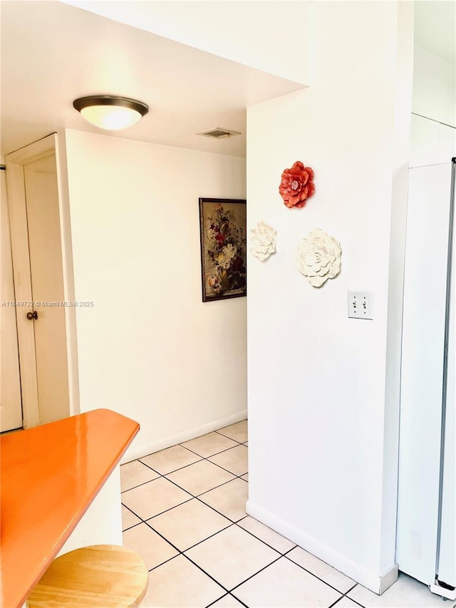 hallway featuring light tile patterned floors