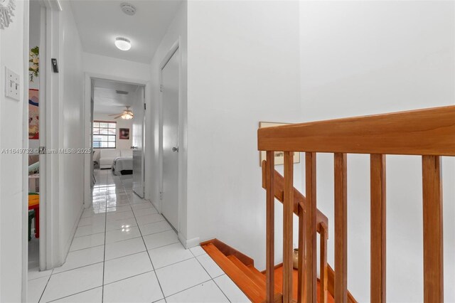 laundry room featuring cabinets, separate washer and dryer, and light tile patterned floors