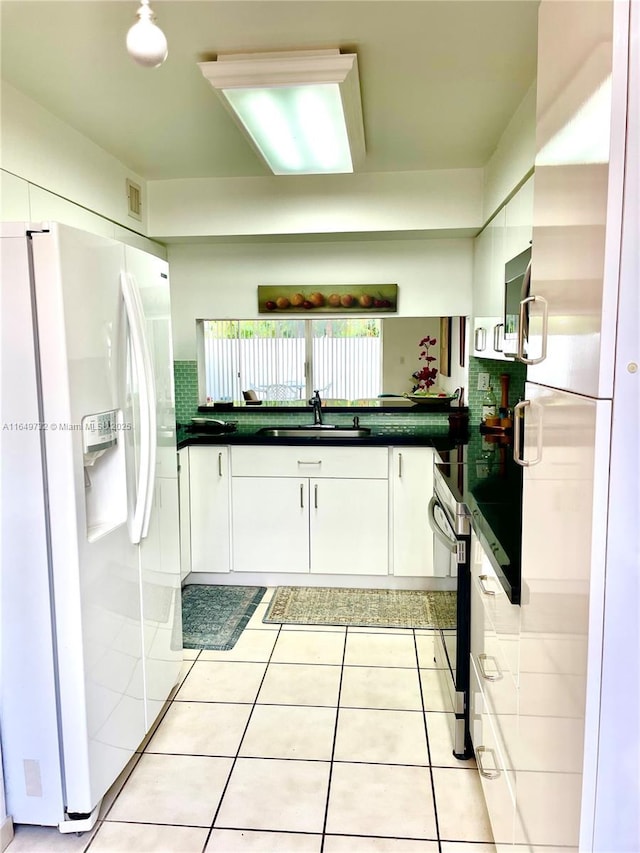 kitchen featuring white cabinetry, sink, oven, white refrigerator, and white refrigerator with ice dispenser